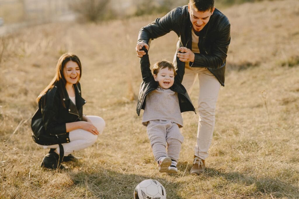 pexels-photo-4148842-4148842 Family enjoying playful soccer game outdoors, capturing joyful moments.